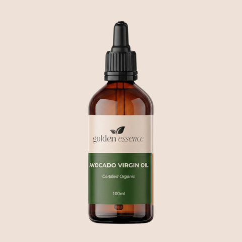 Bottle of avocado virgin oil with 'golden essence' label on a beige background